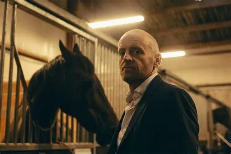 James Brannigan in a stable with a horse — representing the Trust's commitment to equestrian and rural community awareness.
